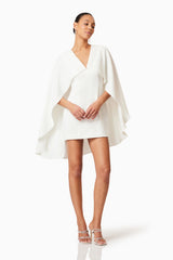 Brunette model wearing Lilydale Cape Mini Dress In White posed shot