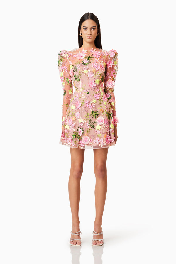 Brunette model wearing Aella Aline Floral Mini Dress In Pink front shot