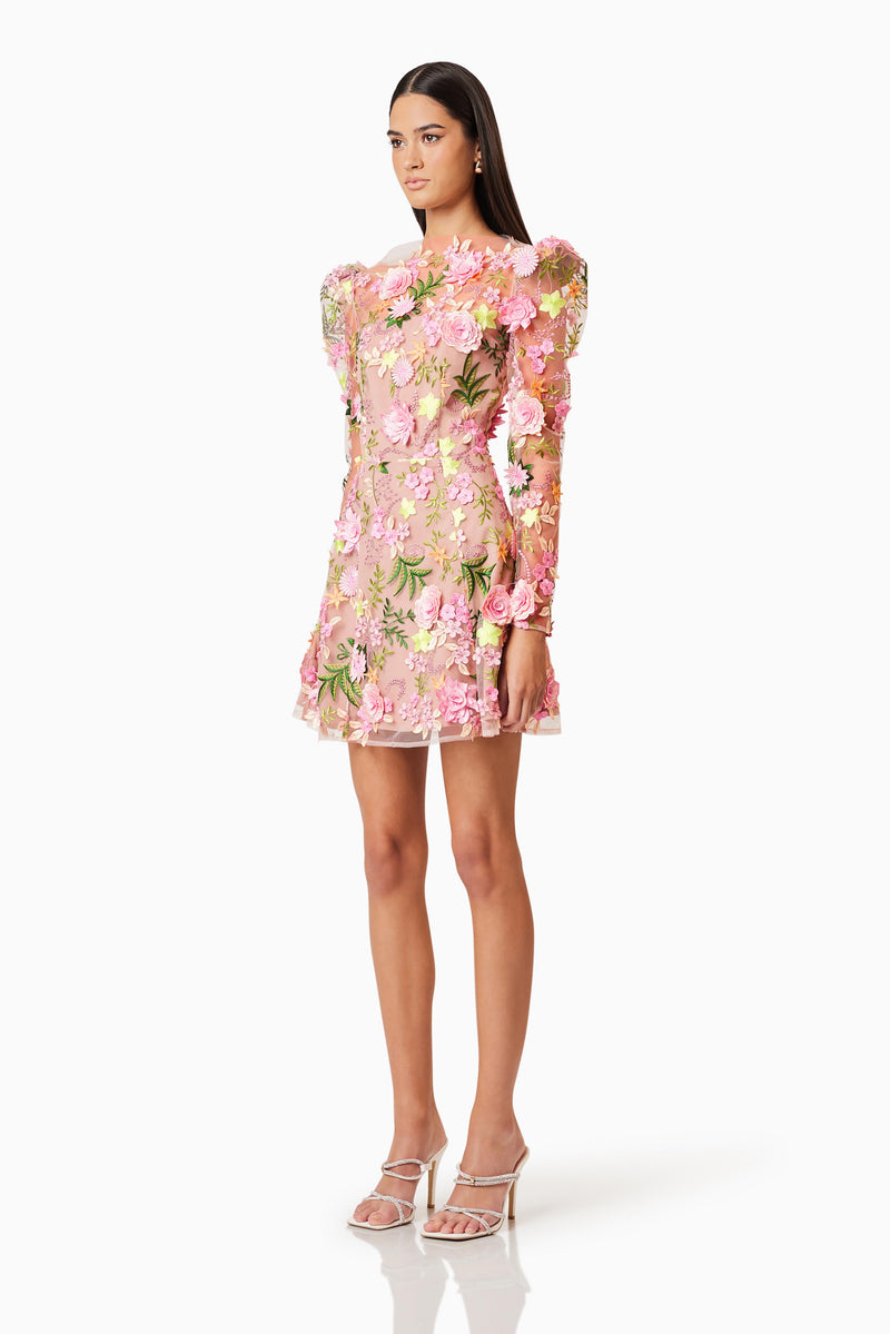 Brunette model wearing Aella Aline Floral Mini Dress In Pink side shot