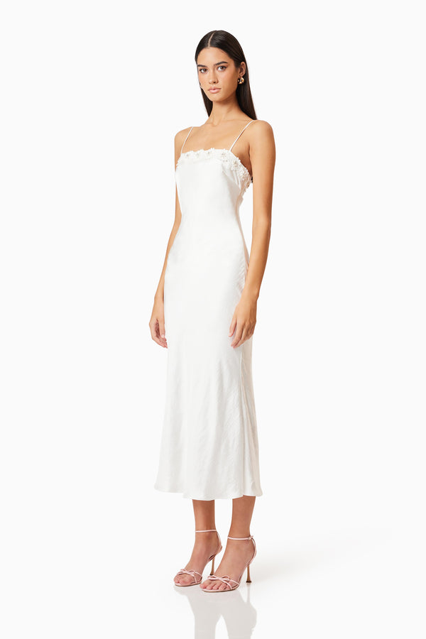 Brunette model wearing Clarissa Midi Dress In White side shot