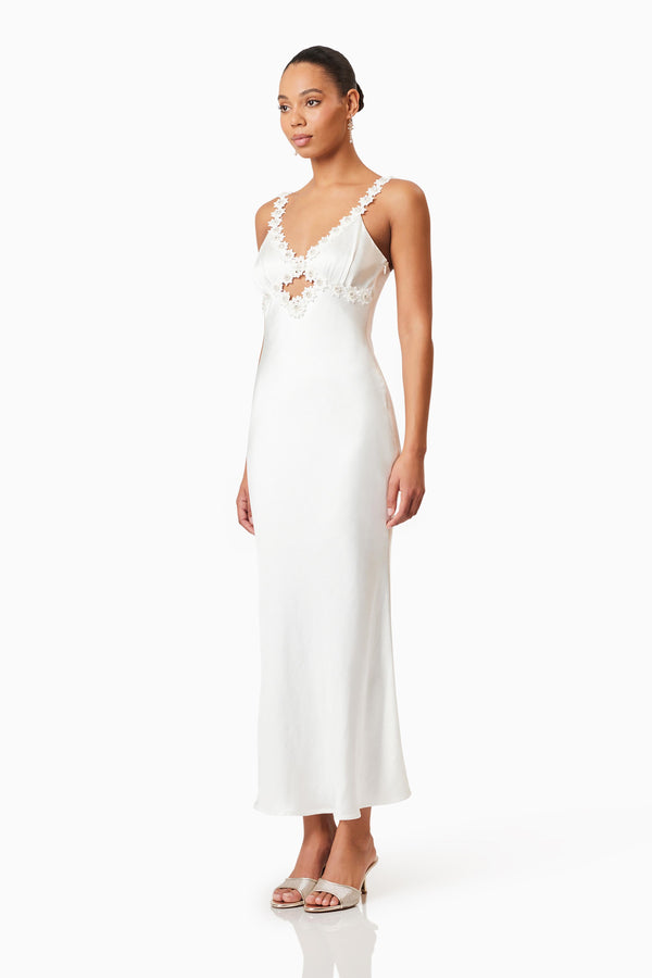 Brunette model wearing Clarissa Maxi In White side shot