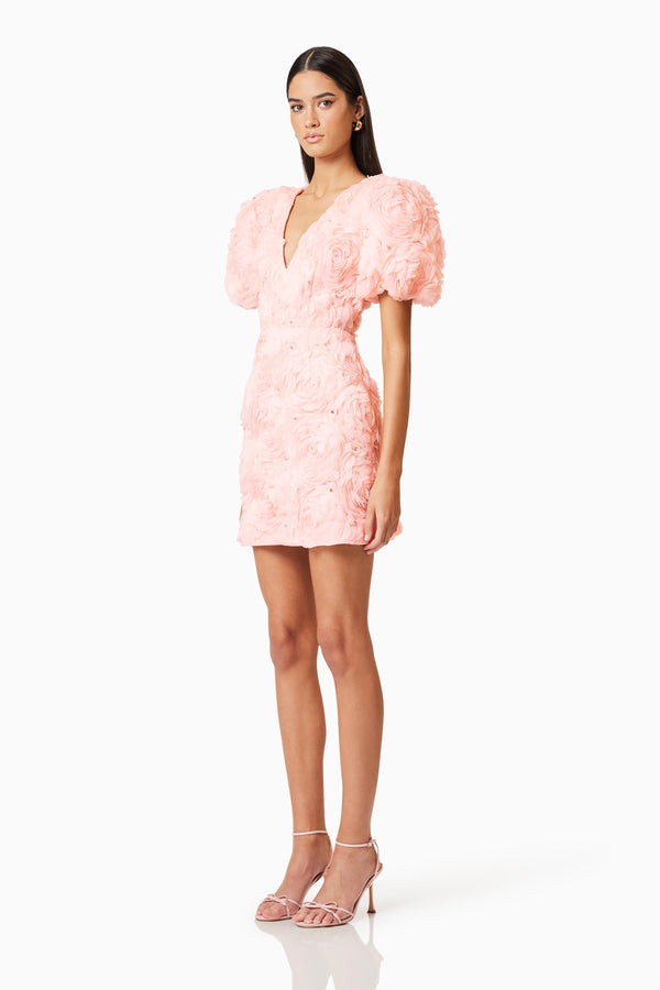 Brunette model wearing Rosella 3D Mini Dress In Pink side shot