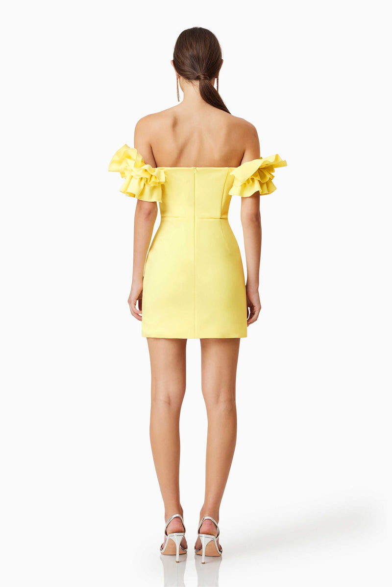 model wearing Nola Off The Shoulder Mini Dress In Yellow back shot