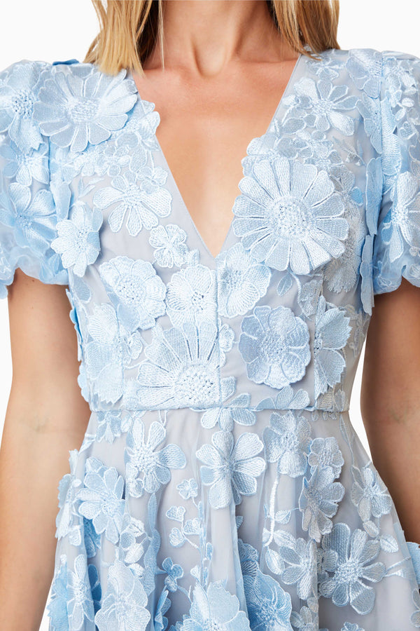 model wearing Selene Floral Mini Dress In Blue close up shot