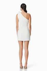 Brunette model wearing Celia Mini Asymmetrical Dress in White back shot