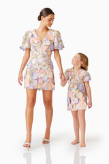 Female model posing with a child model wearing Anthea Embroidered Dress in Purple looking holding hands