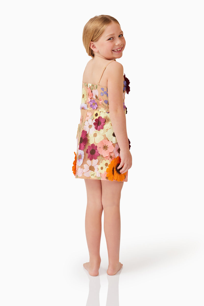 Blonde child model wearing Rosalind Girls Dress in Floral back side shot