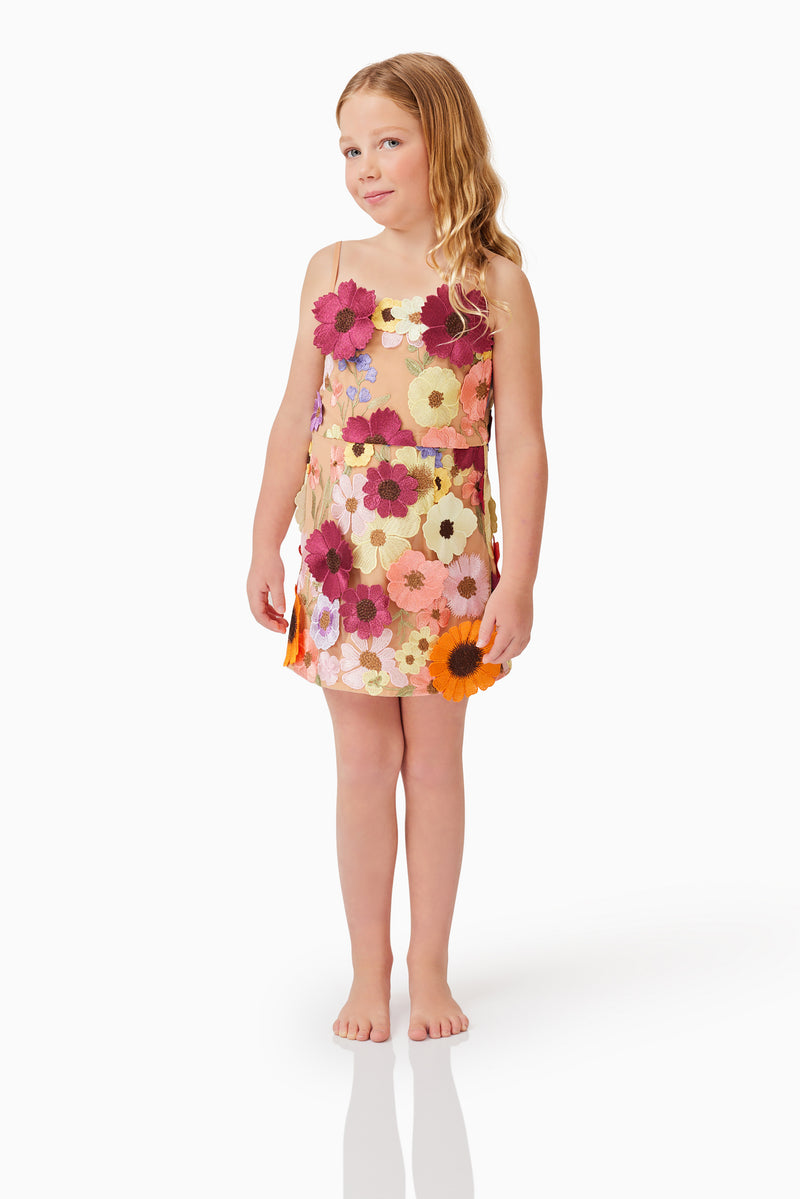 Blonde child model wearing Rosalind Girls Dress in Floral natural shot