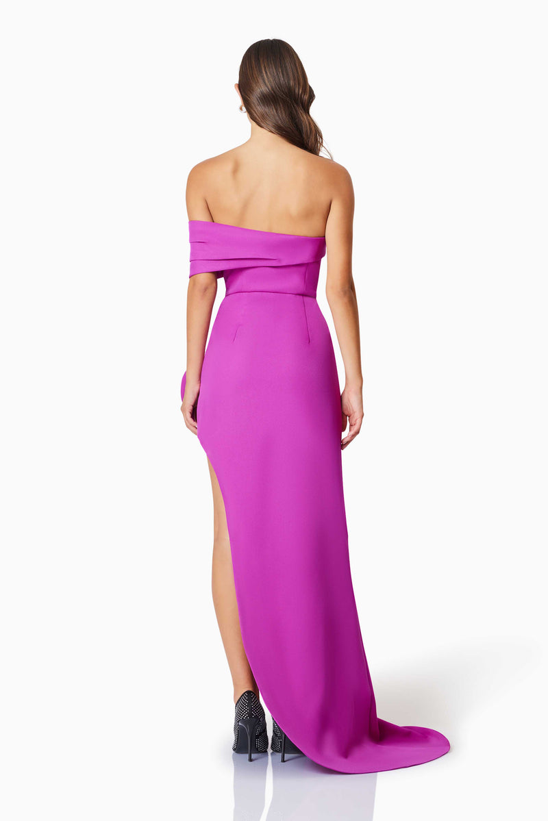 model wearing Bethany Off The Shoulder Maxi Gown In Purple back shot