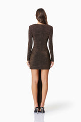 model wearing Nalani Long Sleeve Mini Dress In Brown back shot