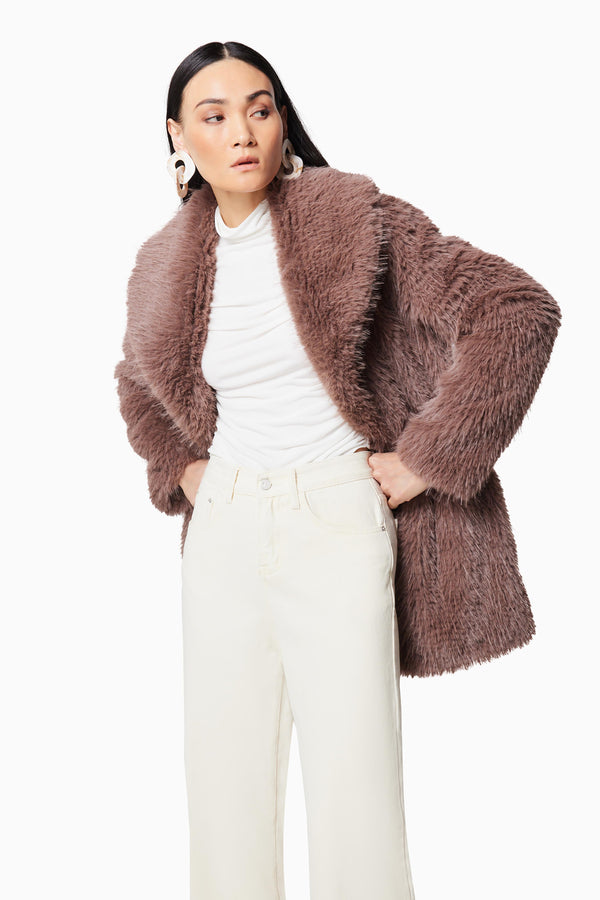 Brunette model wearing WYOMING FAUX FUR COAT IN BROWN closeup shot